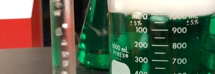 green liquid in glass beaker